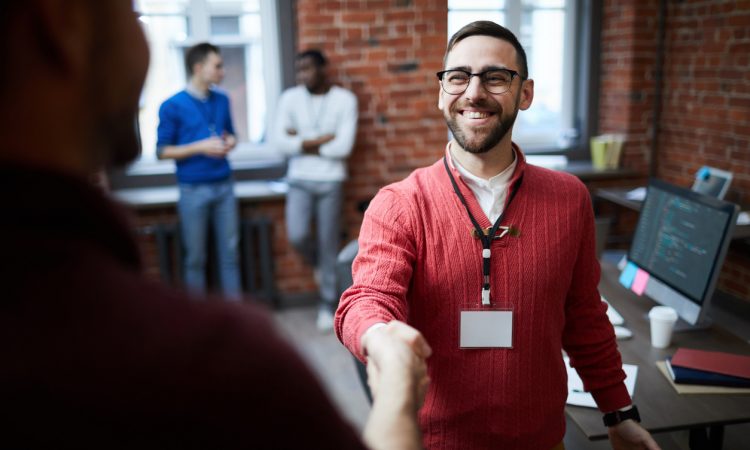 Two people shaking hands at work.