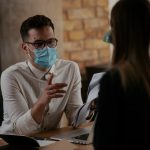 Man and woman talking in office