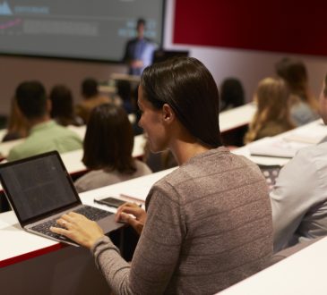 Adult student using laptop computer at a university lecture