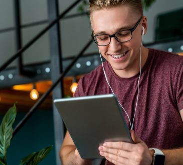 Man smiling and holding tablet