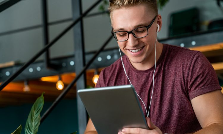 Man smiling and holding tablet