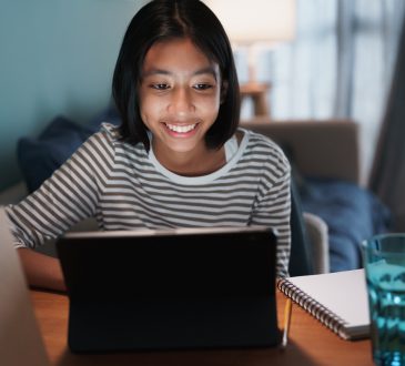 Girl smiling and looking at laptop