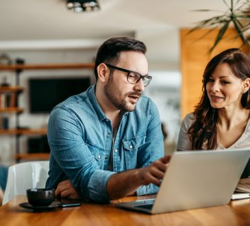 Man and woman looking at laptop at work