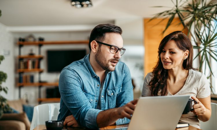 Man and woman looking at laptop at work