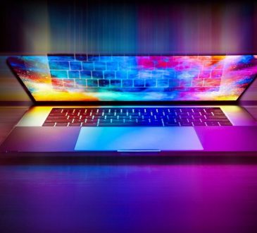 Colourful laptop screen glowing in dark