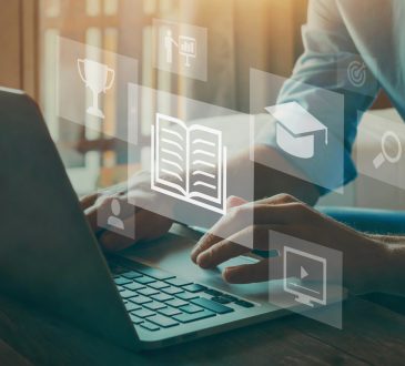 Person typing on computer overlaid with icons representing e-learning
