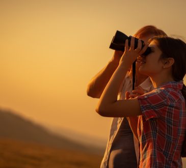 Young woman using binoculars