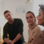 People sitting in circle talking