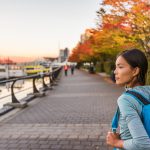 Woman walking alongside harbour in Vancouver