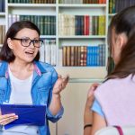 High school teacher having meeting with female student