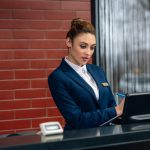 Hotel receptionist using computer