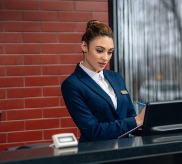Hotel receptionist using computer