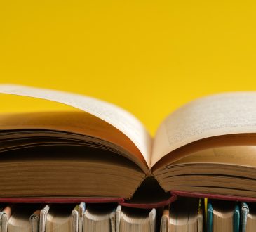 Open book on yellow background