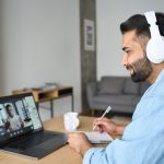 Man watching webinar on laptop