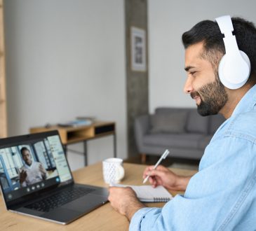 Man watching webinar on laptop