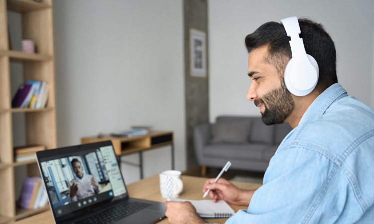 Man watching webinar on laptop