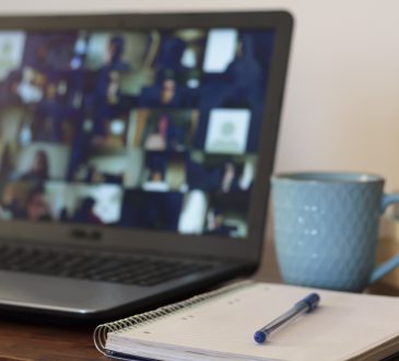 Laptop and notebook on table