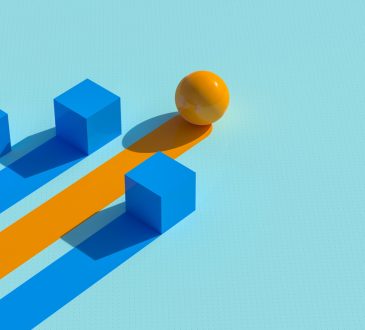 Two cubes and sphere with lines trailing behind as representation of winning business strategy
