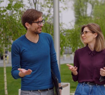 Man and woman having walking meeting outdoors.