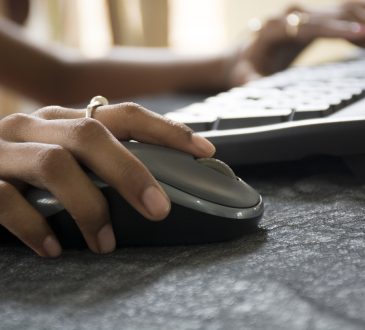 Woman hand with Computer Mouse close up