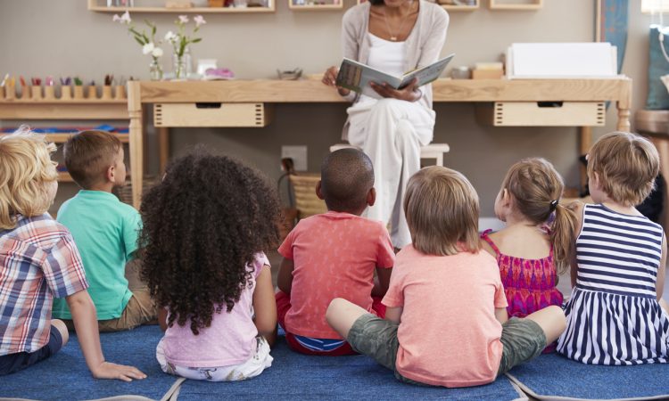 Teacher reading to young students in classroom