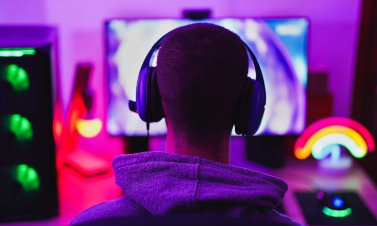Young man playing video games on computer
