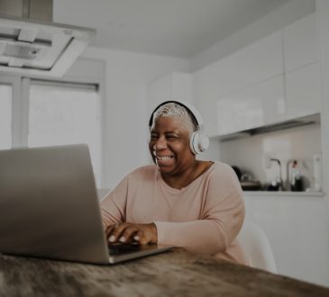 Older woman using laptop in kitchen