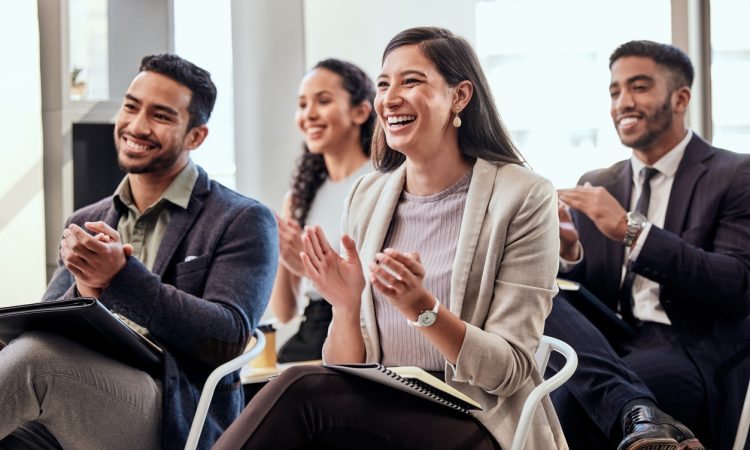 People clapping in audience at conference
