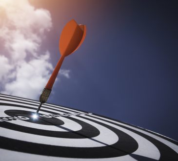 Dart board against blue sky