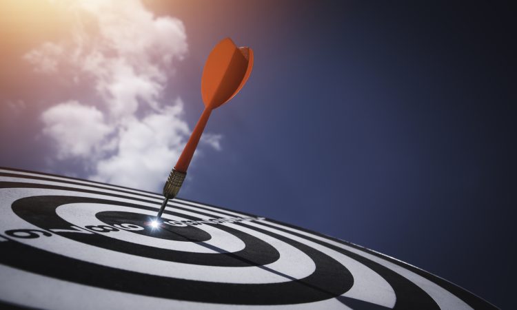Dart board against blue sky