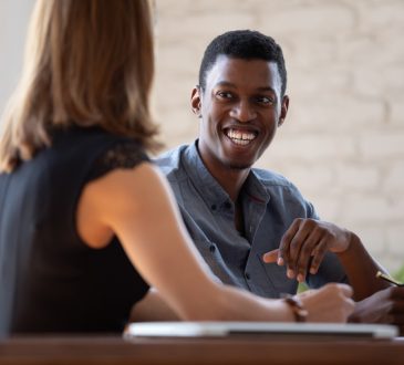 Man and woman talking in office