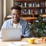 Man using laptop in cafe