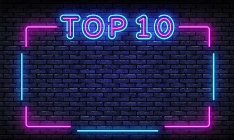 Neon sign reading Top 10 on brick wall
