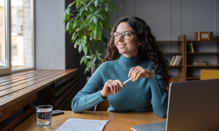 Woman sitting at desk smiling