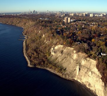 Aerial view of Scarborough Bluffs with Toronto downtown as far away background.