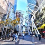 Pedestrians walking past retail outlets along Stephen Ave in Autumn in Calgary.