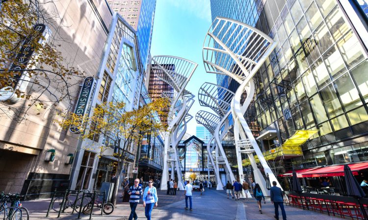 Pedestrians walking past retail outlets along Stephen Ave in Autumn in Calgary.