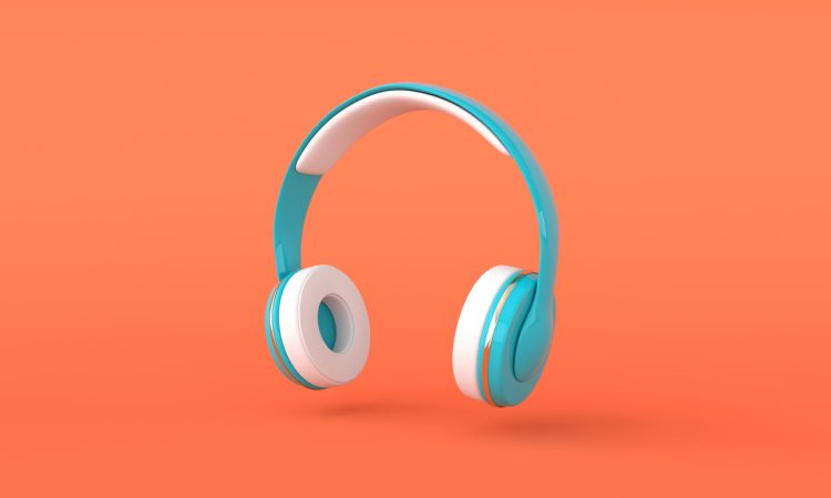 Teal over-ear headphones on orange background