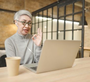 Woman on video call on laptop in office