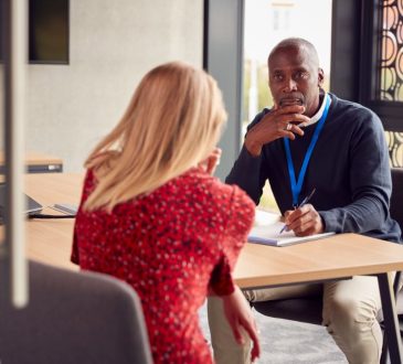 Man and woman sitting at table talking