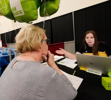 People talking at career fair.