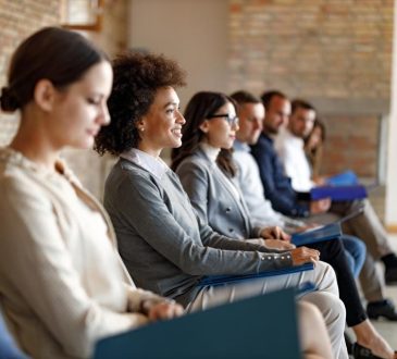 People sitting waiting to be called in for job interview