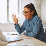 Young woman having video call via laptop in the office