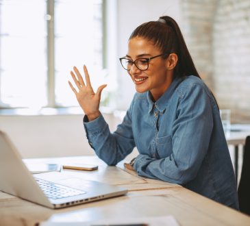 Young woman having video call via laptop in the office