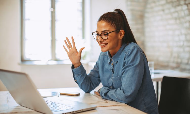 Young woman having video call via laptop in the office