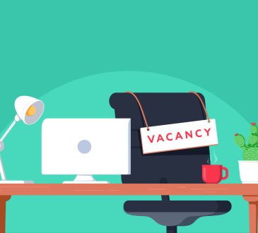 Desk in office with vacancy sign hanging on chair