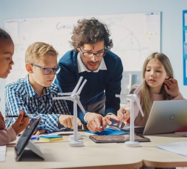 Teacher with group of middle-school students in classroom