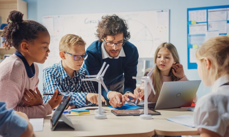 Teacher with group of middle-school students in classroom