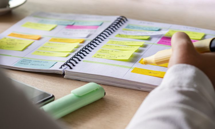 Close-up of hand writing in agenda