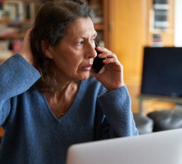 Woman stressed on phone call.